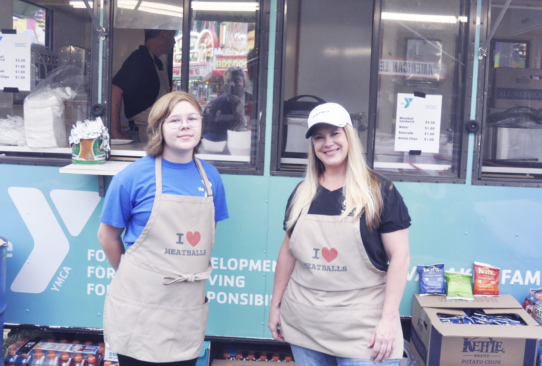 Emma Czyznik and Sherri Baker at YMCA booth at Venetian Fest